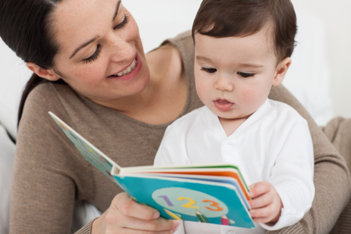 Mother reading with baby son